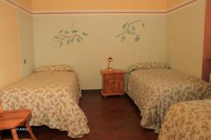 Postel nebo postele na pokoji v ubytování Agriturismo La Praduscella