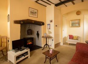 a living room with a couch and a fireplace at Church Lane Cottage in Llanidloes