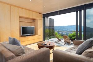 a living room with a couch and a television at Glencoe 40 in Cape Town