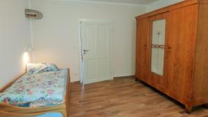 a bedroom with a dresser and a bed and a cabinet at Mirabellenhof-Fewo mit Terrasse in Biesenthal