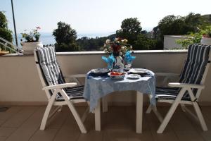 a table and two chairs on a balcony at Open Hus in Krvavica