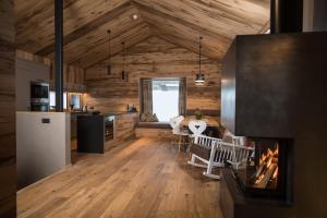kuchnia i jadalnia z kominkiem w kabinie w obiekcie Stadl Lofts Plattenalm - Premiumchalets - Zillertal - Tirol - Salzburg w mieście Krimml