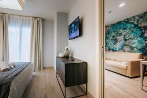 Televízia a/alebo spoločenská miestnosť v ubytovaní Aparthotel Touring