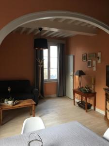 a living room with a couch and a table at Appartement de L'Escale in Honfleur