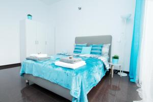 a bedroom with a bed with blue and white pillows at Blue River - Walonska 7 - Apartment with garden in Wrocław