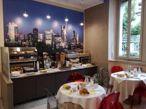 a restaurant with two tables and a view of a city at Hotel Piacenza in Milan