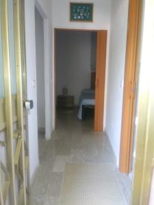 Un pasillo con una habitación con una cama. en Casa Swami, en La Spezia