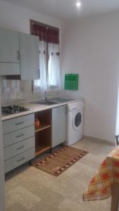 a kitchen with a sink and a washing machine at Casa Swami in La Spezia