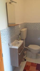 a bathroom with a toilet and a sink and a mirror at Casa Swami in La Spezia +2 photos