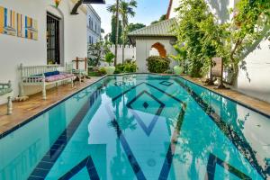 a swimming pool in front of a house at Kholle House in Zanzibar City