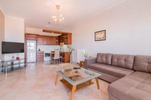 a living room with a couch and a table at Venilia Apartments-2 in Zakynthos Town