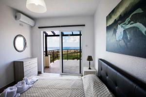 a bedroom with a bed and a sliding glass door at Diamond Townhouse 17 in Paphos +48 photos