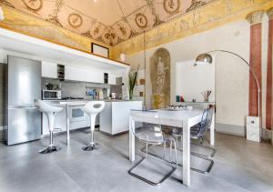 a kitchen with a white table and chairs at La Suite del Principe in Palermo