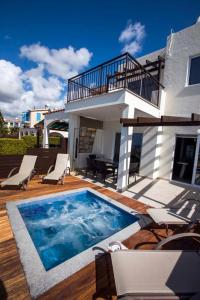 a swimming pool in front of a house at Diamond Townhouse 17 in Paphos