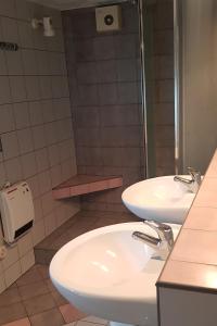 a bathroom with two sinks and a shower at Willa Końiczynka in Zakopane