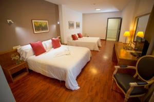 Postel nebo postele na pokoji v ubytování Hotel Borgia