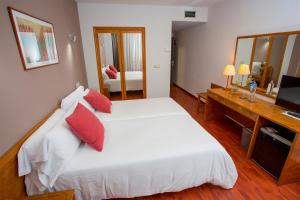 Postel nebo postele na pokoji v ubytování Hotel Borgia