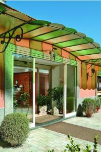 a building with awning on the side of it at Montespina Park Hotel in Naples