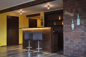 a bar with two black chairs and a brick wall at Hotel Diamant Borsheva in Bronnitsy