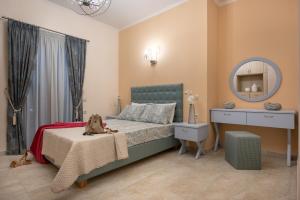 a bedroom with a bed with a dresser and a mirror at Aquarella Luxury Apartment in Argasi +13 photos