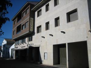 a brick building with windows on the side of it at Hotel Chané in Puebla de Alfindén