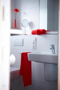 a bathroom with a sink and a red towel at Gästehaus Weingut Mathy-Schanz in Osann-Monzel
