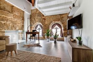 a living room with a stone wall at La Suite del Principe in Palermo