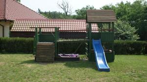 a playground in a yard with a slide and a slope at Na Plebanii in Jaszkowo