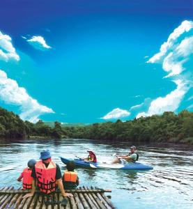 a group of people in kayaks on a river at Vorona Resort in Sai Yok