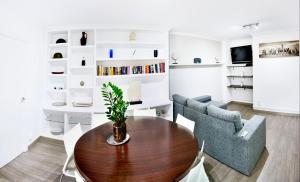 a living room with a table and two chairs at Sèquia Deluxe Apartment in Girona