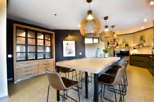 a kitchen with a large wooden table and chairs at Zebula Golf Estate & Spa Executive Holiday Homes in Mabula