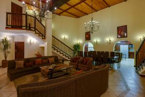 a living room with couches and a dining room at Zebula Golf Estate & Spa Executive Holiday Homes in Mabula