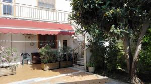 a house with a staircase and a tree at orlando in Porto Garibaldi