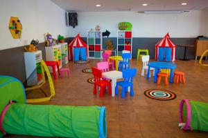 a room with colorful chairs and tables and chairs at Hotel Don Pablo in Gandía