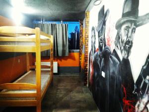 a room with a bed and a wall with a painting at Graffiti Mega City in Kyiv