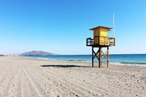a lifeguard tower on a sandy beach near the ocean at Altos de Nuevo Vera in Vera