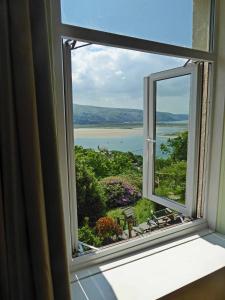 an open window with a view of the water at Bryn Melyn Apartments in Barmouth