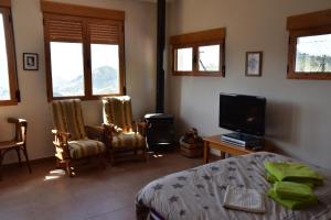 a bedroom with a bed and a flat screen tv at Villa Pico in Sella