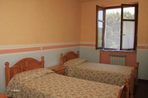 Postel nebo postele na pokoji v ubytování Agriturismo La Praduscella