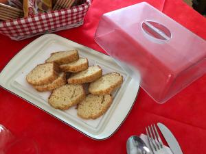 a plate of bread on a table with a pink box at Villa Cenzina in Marina di Pisticci