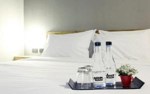 Postel nebo postele na pokoji v ubytování Izen Plus Budget Hotel & Residence