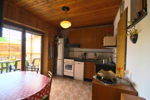 a kitchen with a table and a kitchen with a dining room at Chalupa Slota in Gôtovany