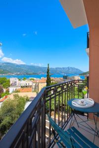 a balcony with a table and chairs and a view at Chiron Apartments in Budva