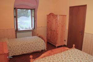 Postel nebo postele na pokoji v ubytování Agriturismo La Praduscella