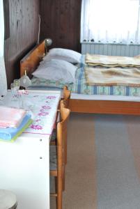 a bedroom with a bed and a table with chairs at Farm Stay Bogša in Ormoz +35 photos