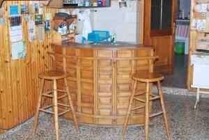 a wooden bar with two stools and a counter at Farm Stay Bogša in Ormoz