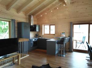 a kitchen with wooden walls and a wooden floor at Walser Berg Chalets in Riezlern