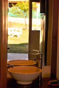 a bathroom with a bowl sink and a mirror at Complejo Retana in Potrero de los Funes