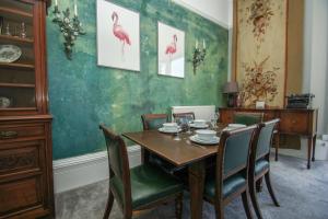 布萊頓霍夫的住宿－Regency Apartment - Sea View - by Brighton Holiday Lets，一间带木桌和椅子的用餐室