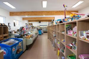a store aisle with shelves of toys and other items at Camping Continental in Bardolino